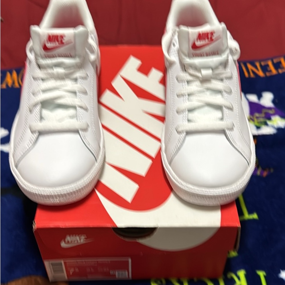 Nike women’s White Sneakers with Red Swoosh Accent